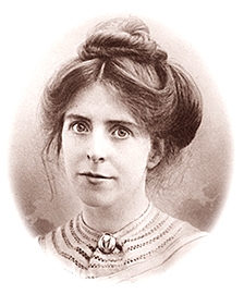 Porträttfoto av Annie Kenney med uppsatt hår, hon ser rakt in i kameran